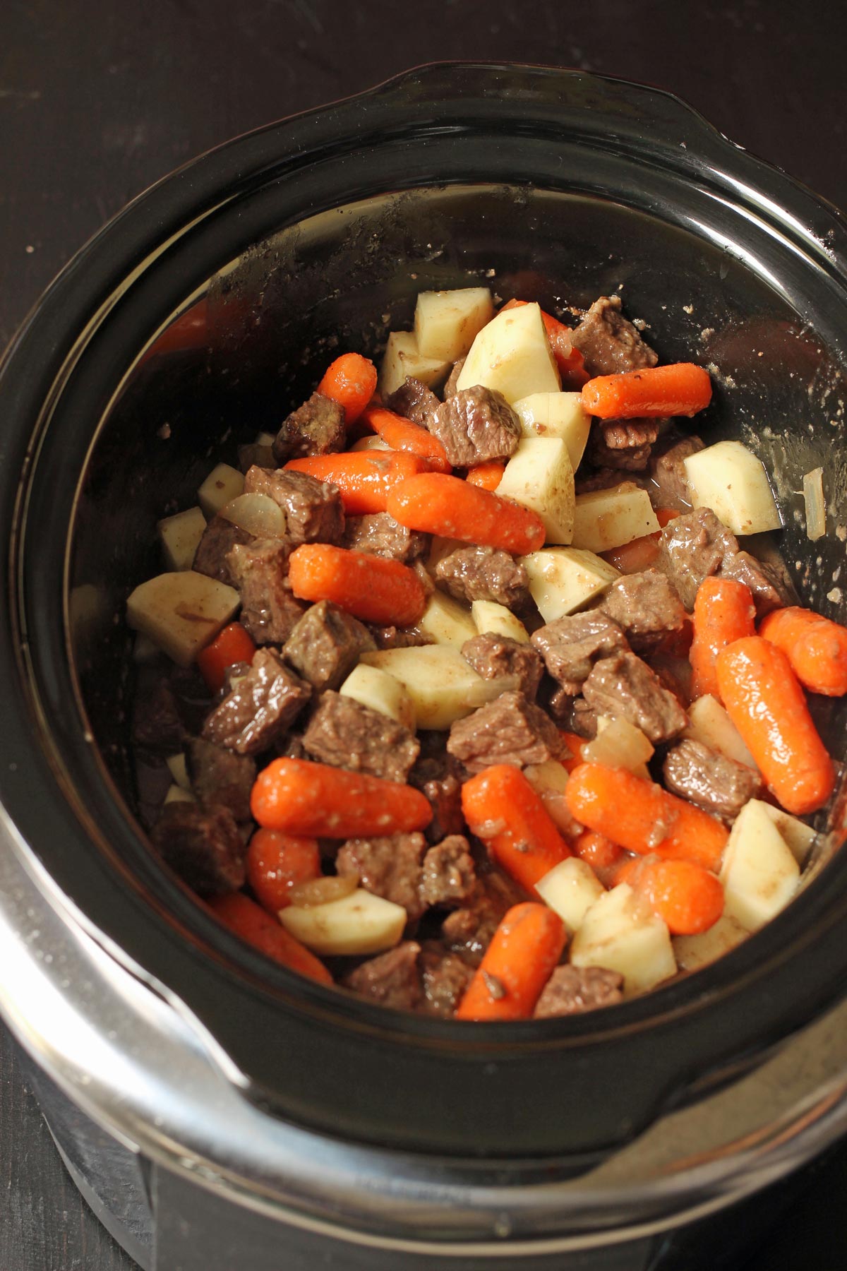 cooked stew in crock of slow cooker.