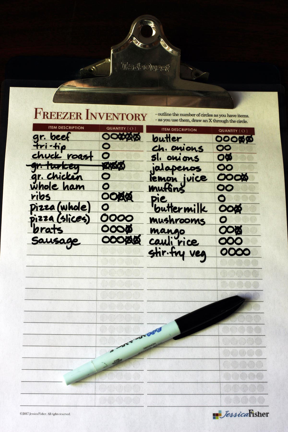 freezer inventory worksheet and wet erase pen on clipboard.