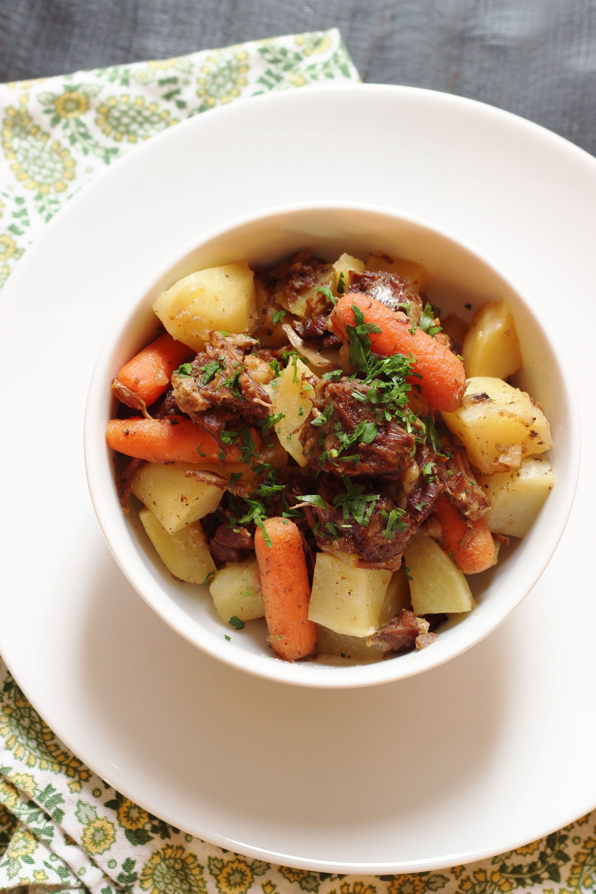 overhead shot of bowl of stew on white plate