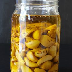 Roasted garlic in a jar of olive oil