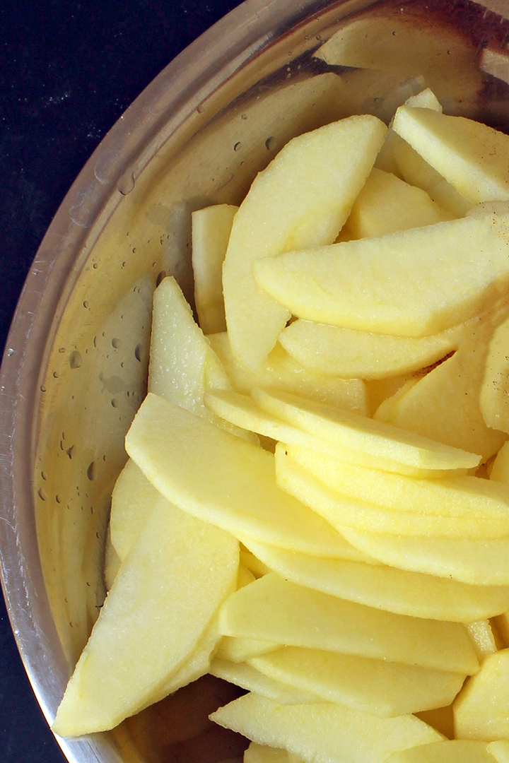 apple slices to prep for freezing in silver bowl