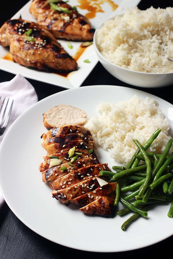 dinner plate of chicken on table set with chicken and rice