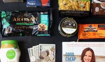 flatlay of groceries cookbook and money with coins and bills