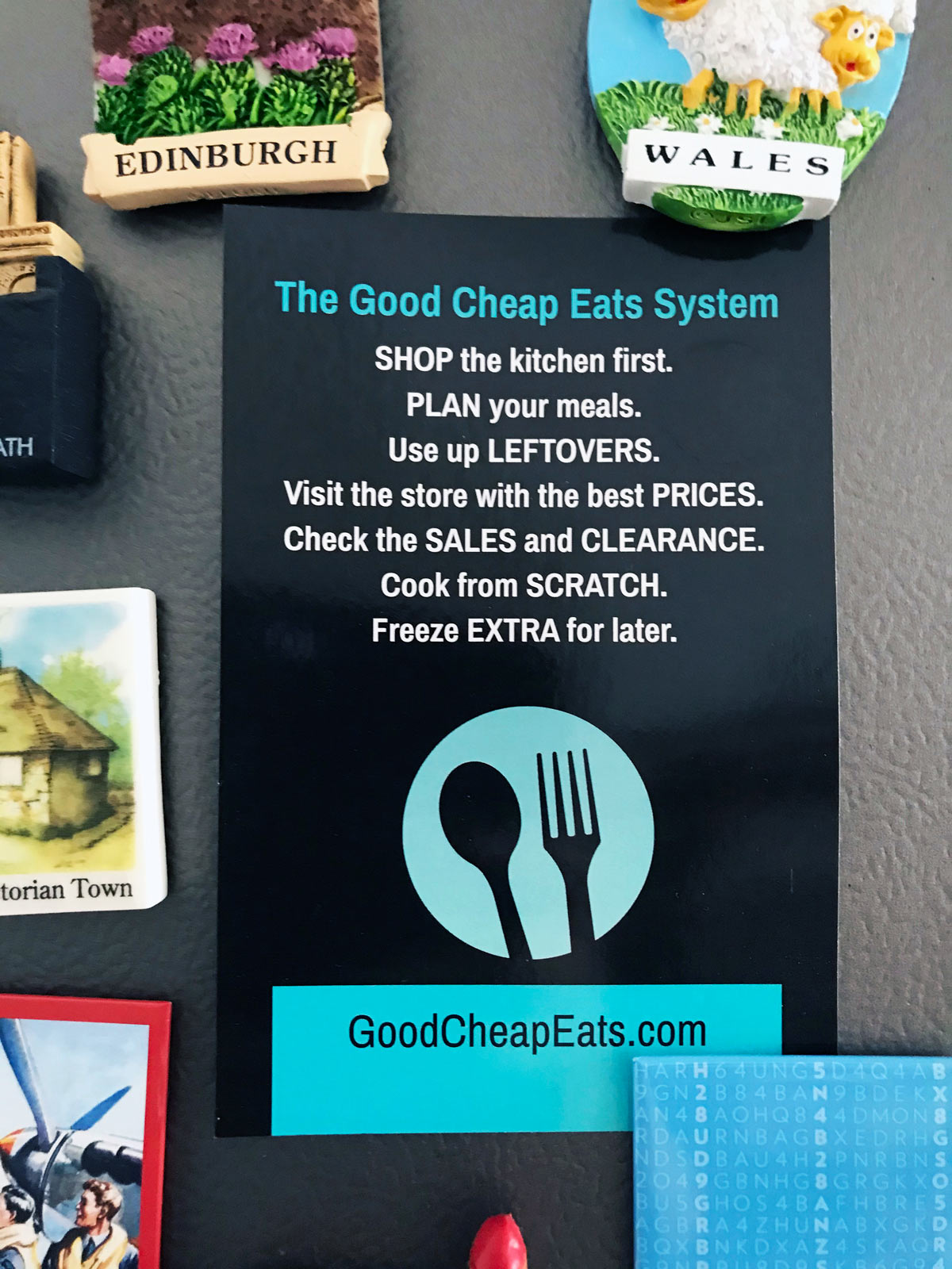 printed card of good cheap eats system on fridge with magnets.