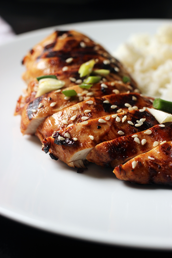 sliced Asian chicken breast on white plate