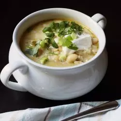 white bowl of chili with spoon and cloth nearby