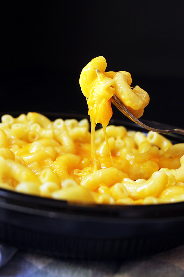 A bowl of mac and cheese with forkful