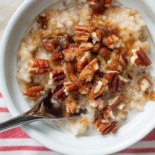bowl of oats with spoon and red striped napkin