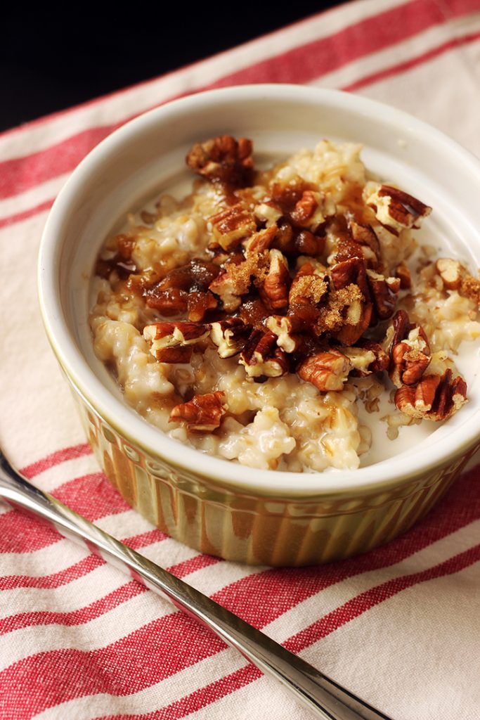 green ramekin with steel cut oats, pecans, and brown sugar