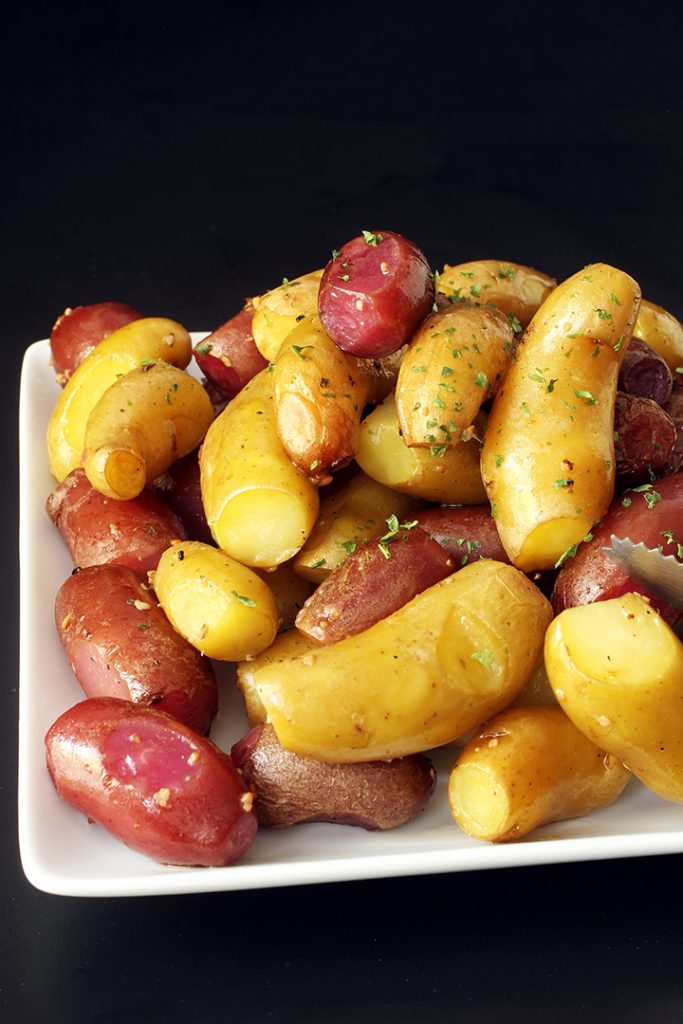 pile of garlic potatoes on square white plate