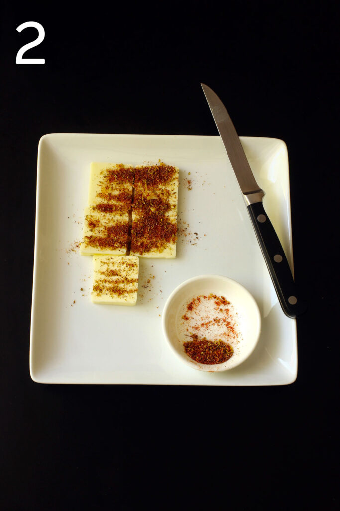 butter on square plate cut into pats and coated with seasoned salt.
