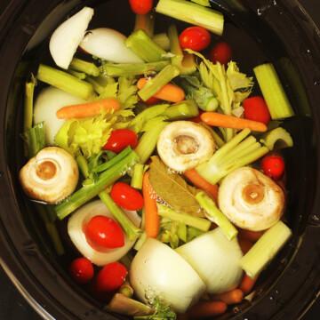 vegetables floating in water in slow cooker