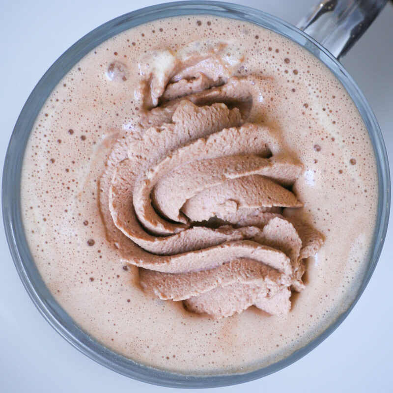chocolate whipped cream in a mug of hot coffee.