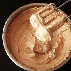 mixing bowl of chocolate whipped cream and beaters
