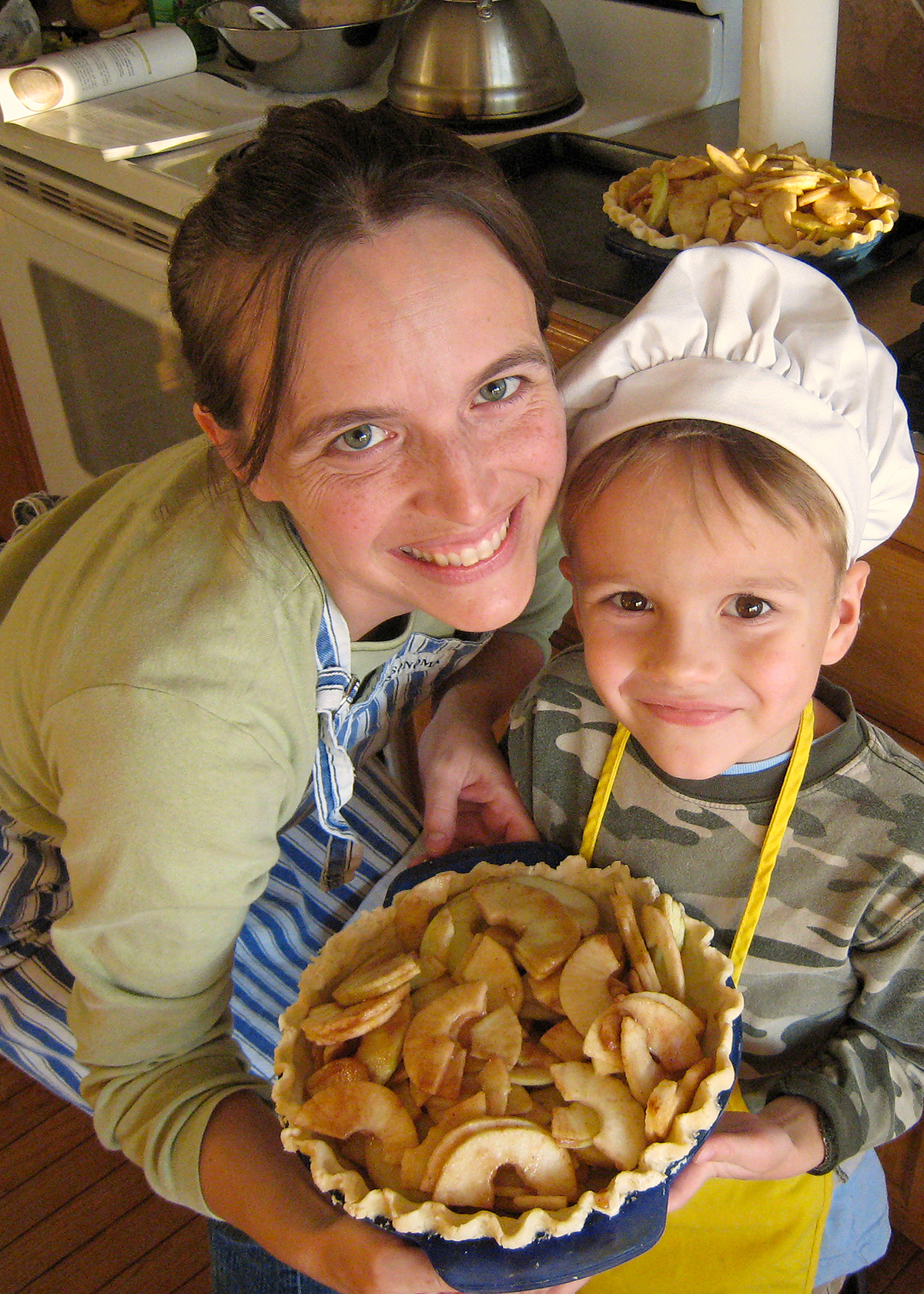 mother and boy holding apple pie they made together