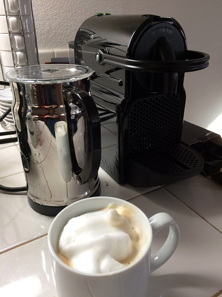 nespresso machine with capuccino and frother