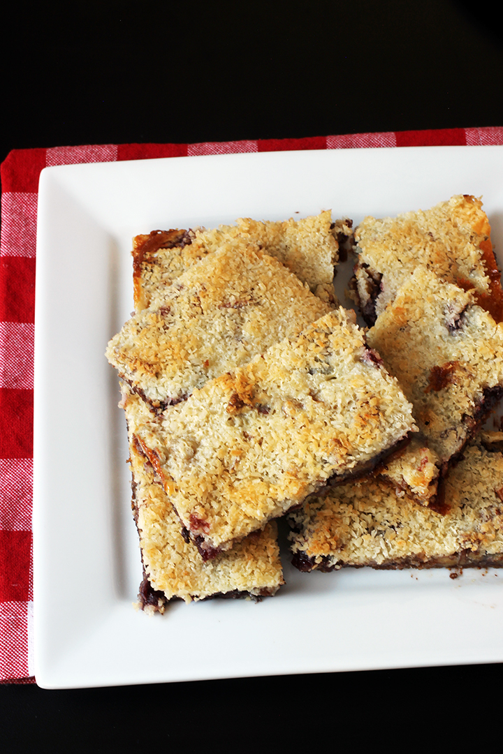 Did You Know There are Over 6,561 Ways to Make Magic Bars?! | Good Cheap Eats platter of cherry jam magic bars on red checked cloth