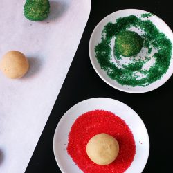 rolling cookie balls in sugar cookies