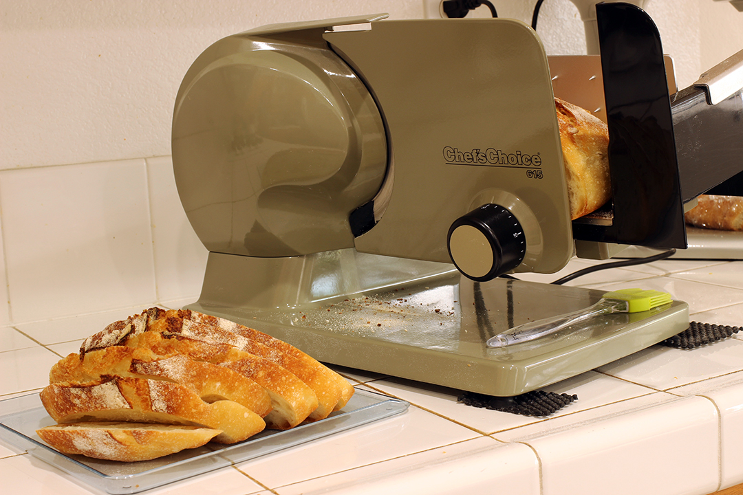 slicing sourdough bread on food slicer