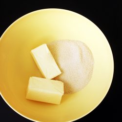 sticks of butter and sugar in yellow bowl