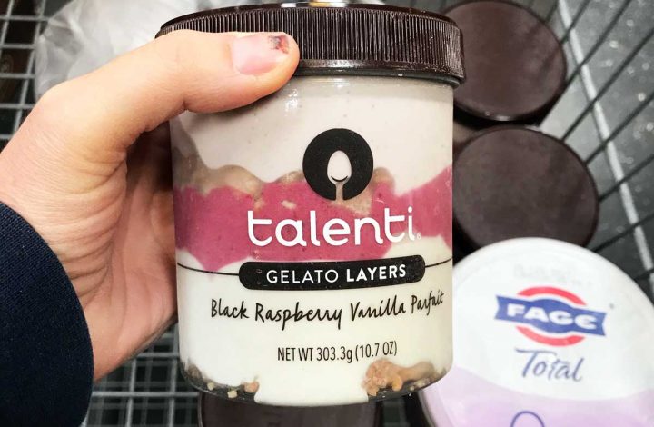 woman holding carton of talent in store