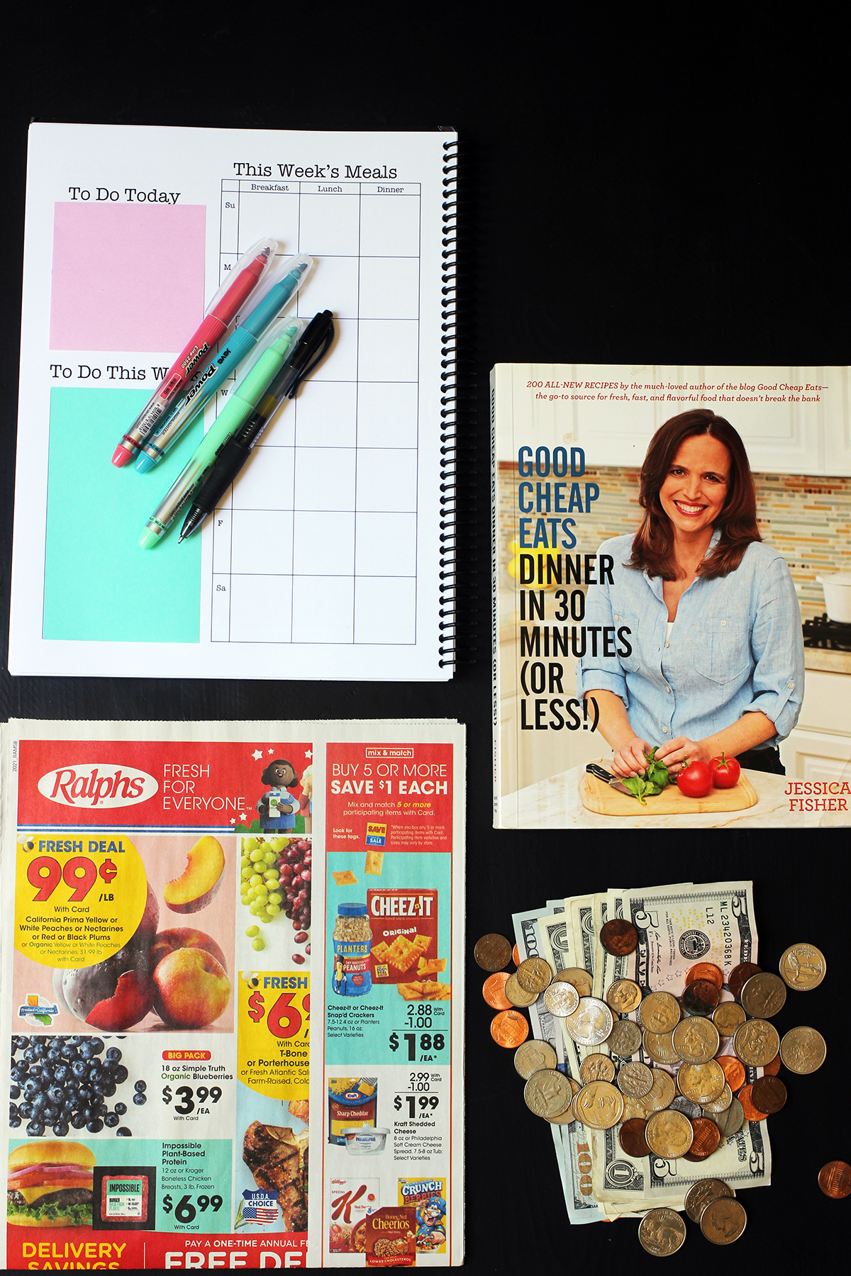 flatlay of planner cookbook grocery ad and money