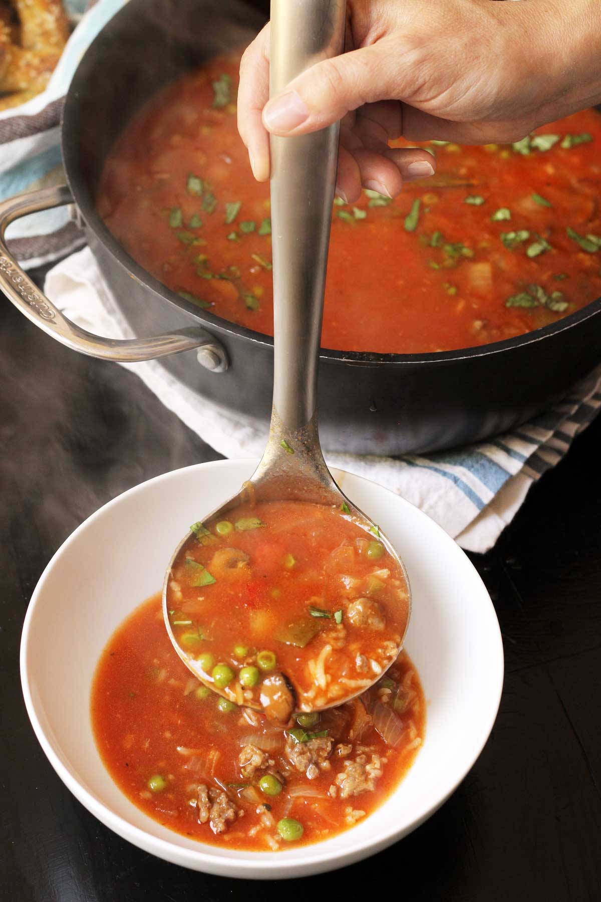 The Easy Meals You Need to Make When There's "Nothing" to Eat ladling soup from pot into bowl
