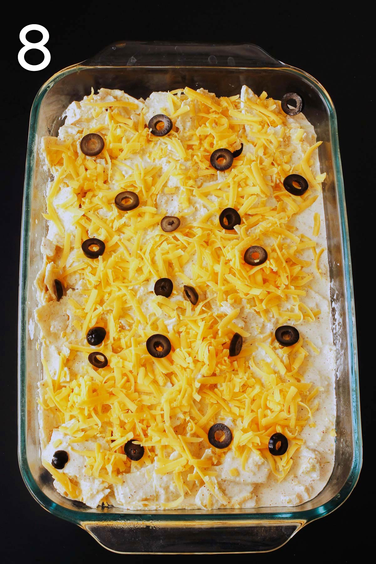 sliced black olives scattered over the top of the cheese layer.