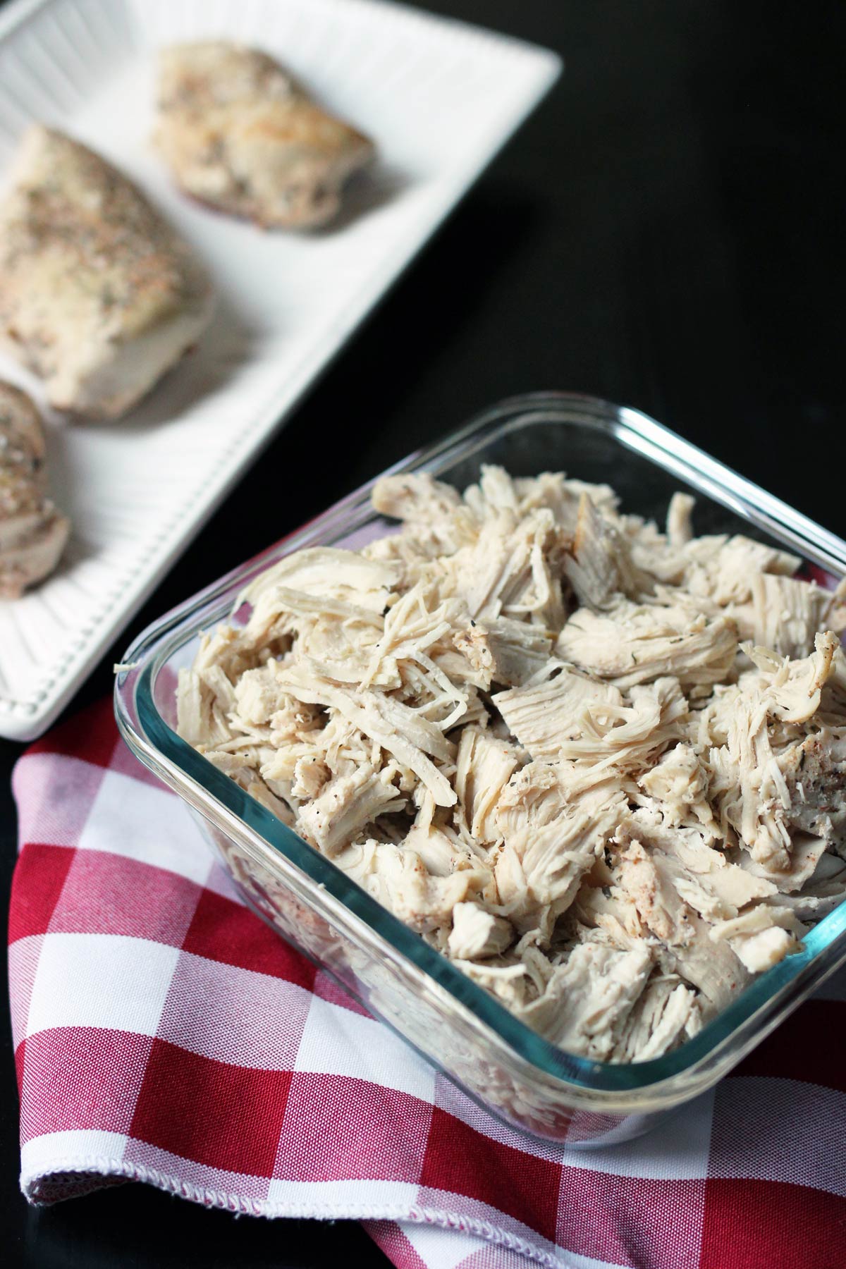 cooked and chopped chicken in glass square dish