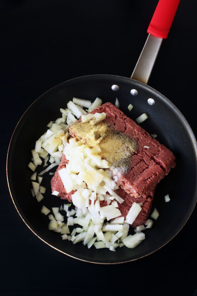 meat, onions, and seasonings in skillet