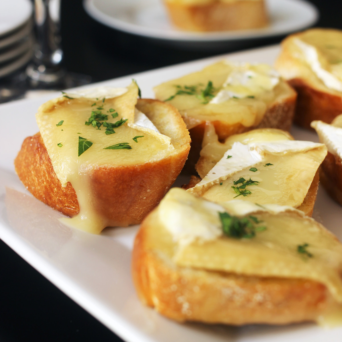 garlic brie toasts on platter