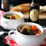 table set with bowls of stew