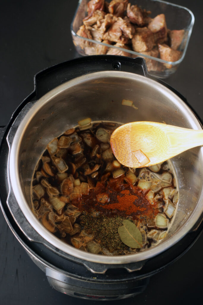 adding spices to pot