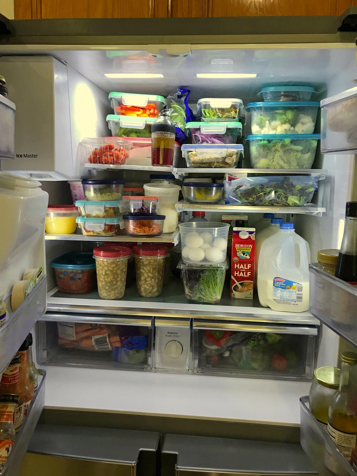 open fridge full of meal prep containers