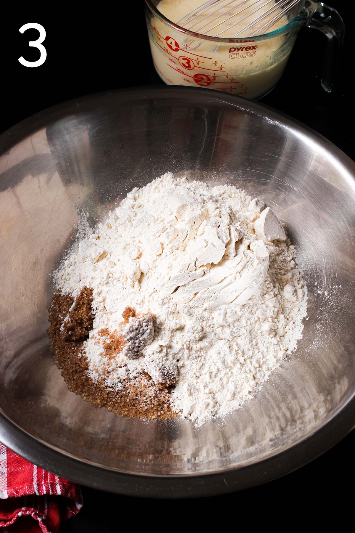 elements for muffin mix in large metal mixing bowl.