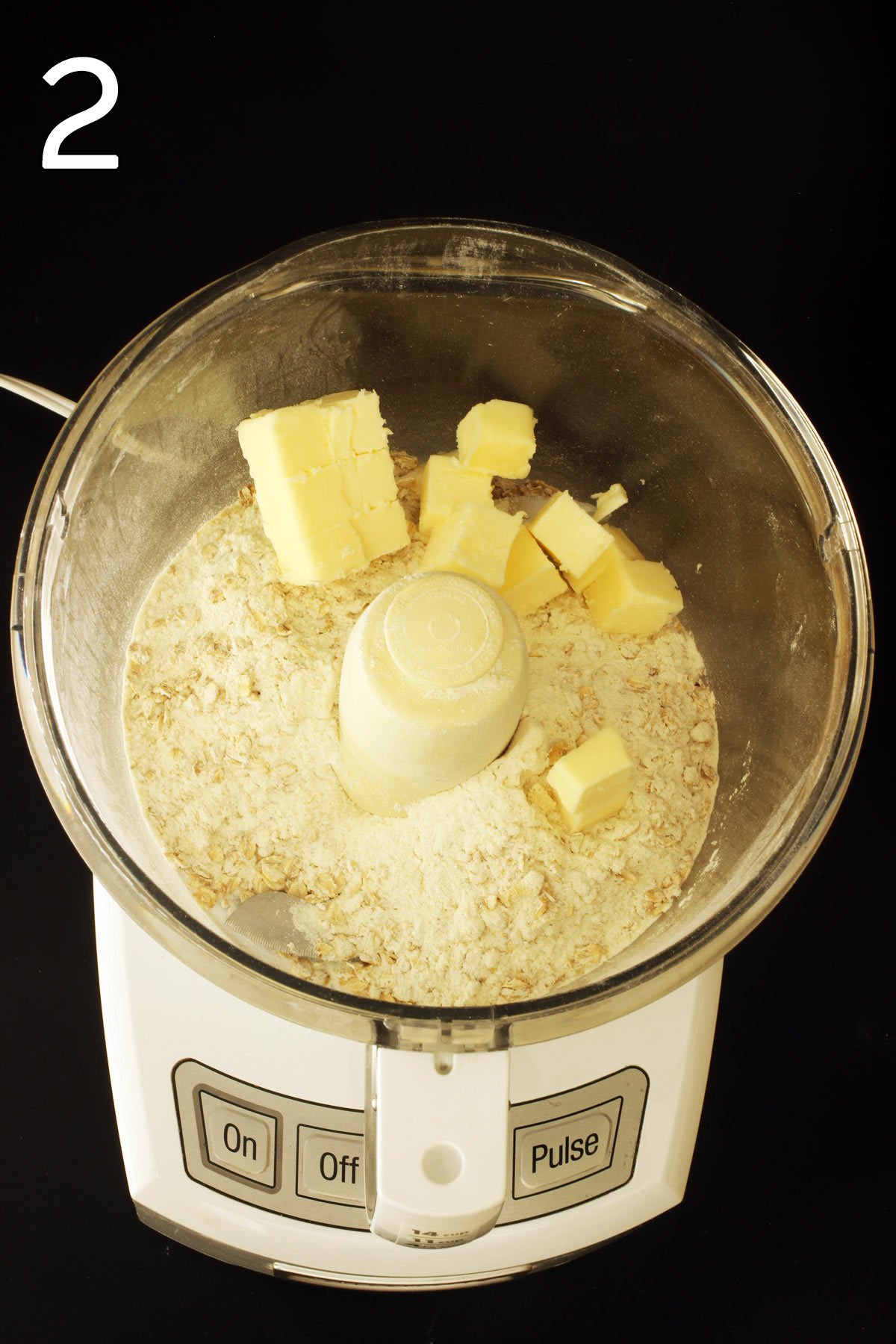adding butter cubes to the food processor.