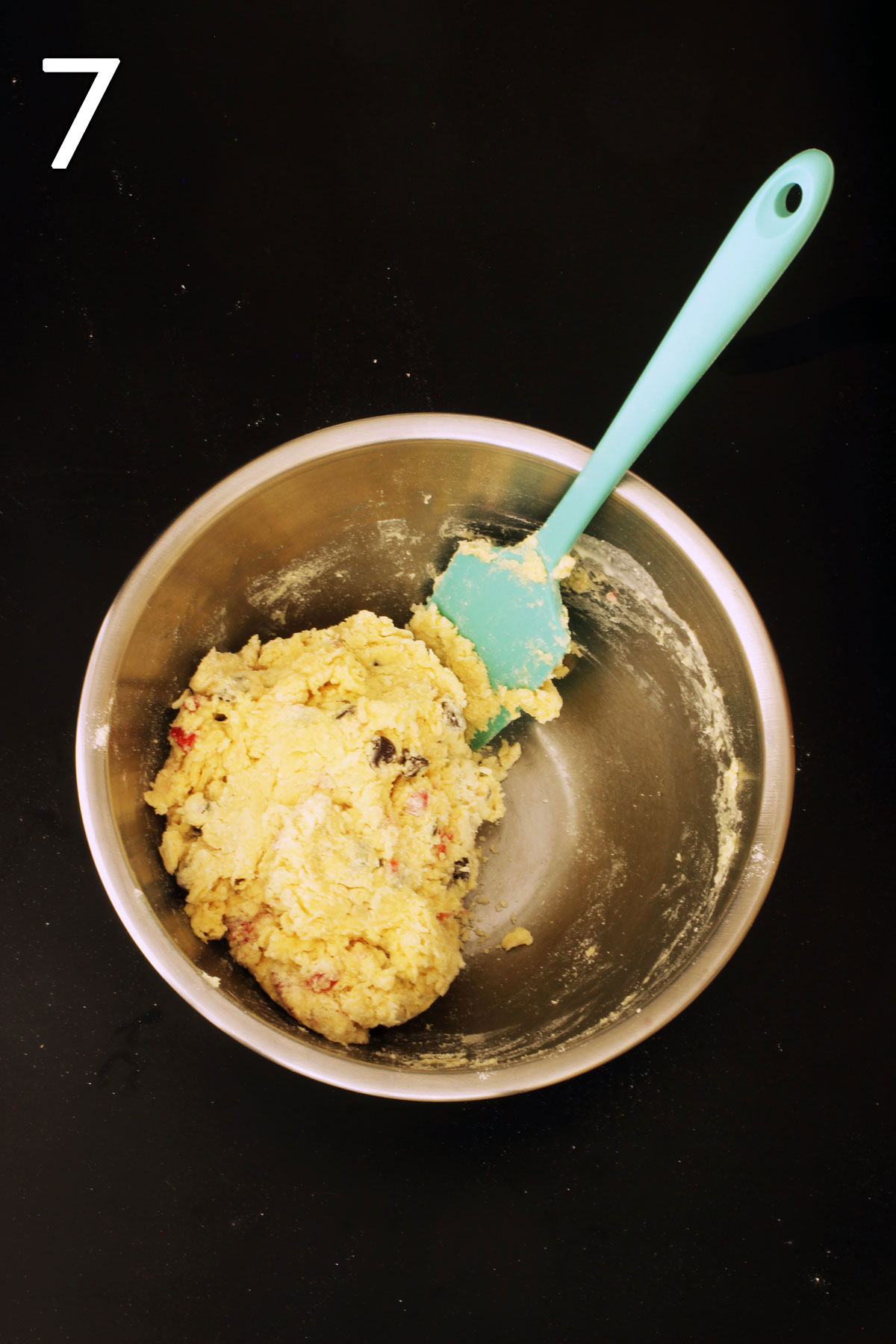batter for scones in mixing bowl with teal spatula.
