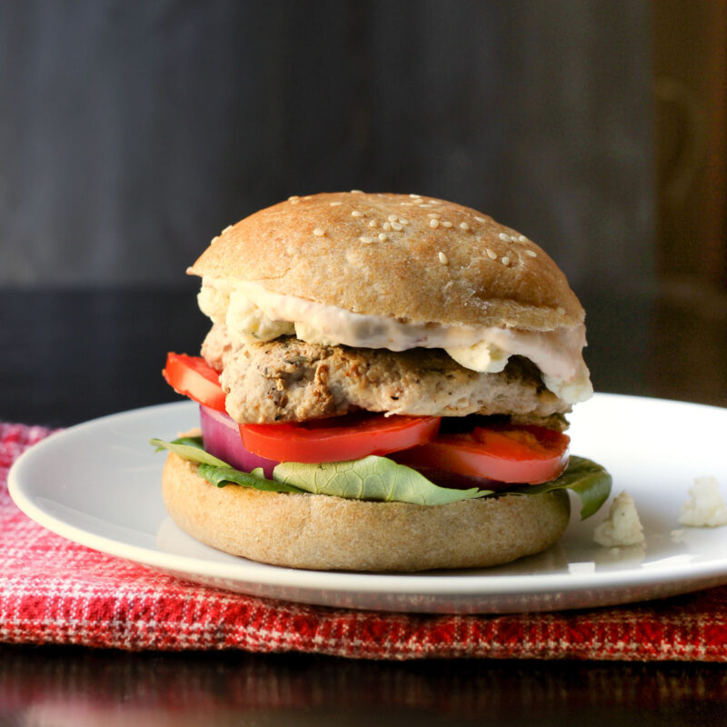 turkey burger loaded with tomato, lettuce, chipotle mayo, and blue cheese on homemade bun.