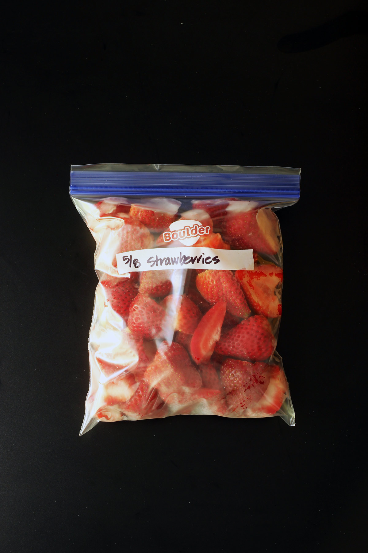 ziptop freezer bag full of frozen strawberries.