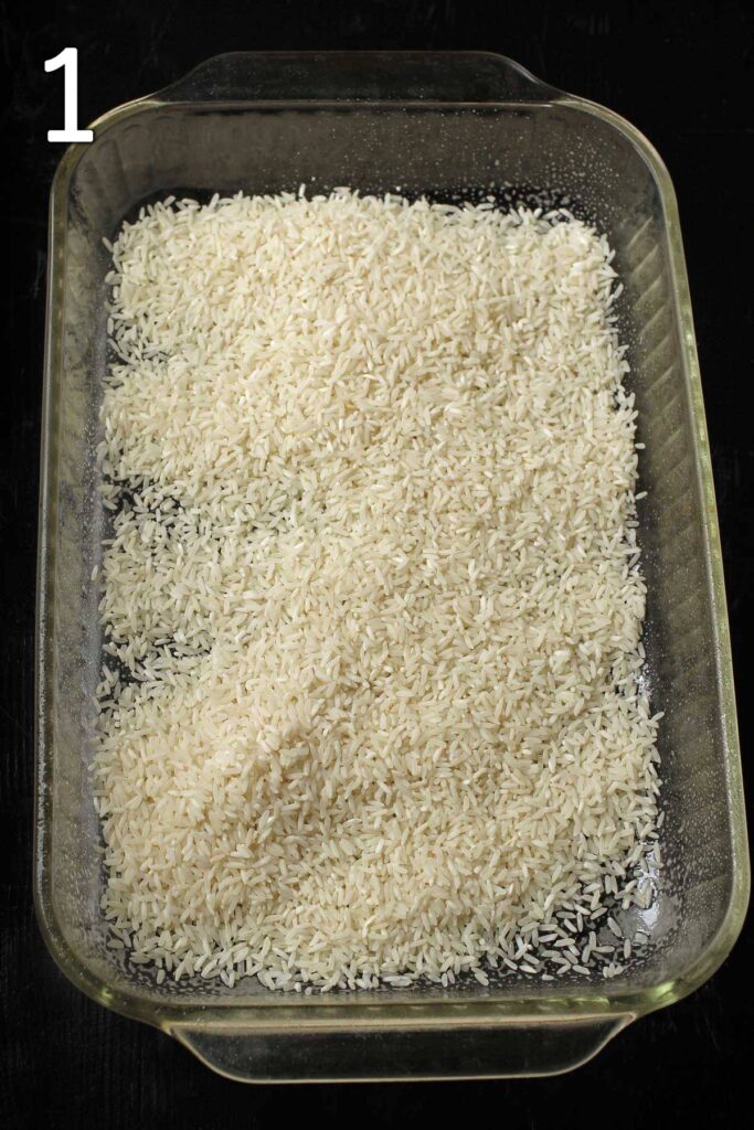 uncooked rice in a layer across the bottom of a 9x13-inch glass baking dish.