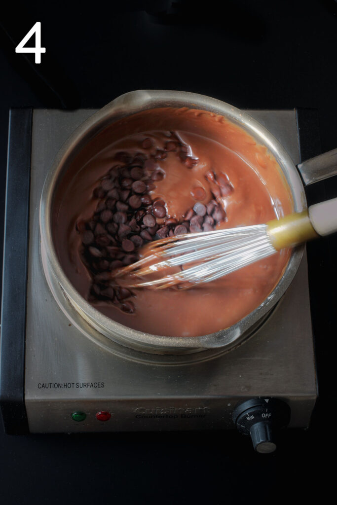 adding the chocolate chips to the pudding in saucepan.
