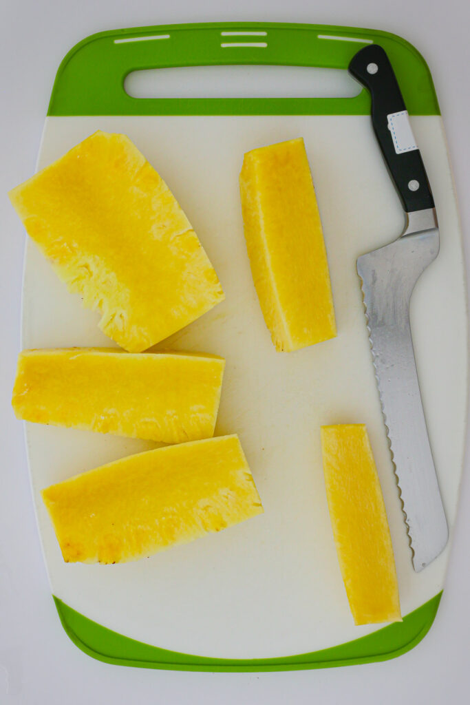 the pineapple wedges surrounding the core on the cutting board.