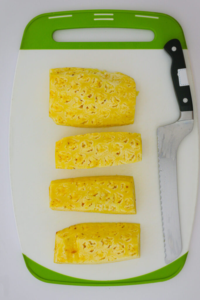 pineapple wedges laid out on the cutting board.