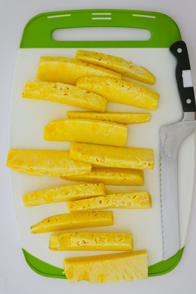 wedges cut into spears on the cutting board.