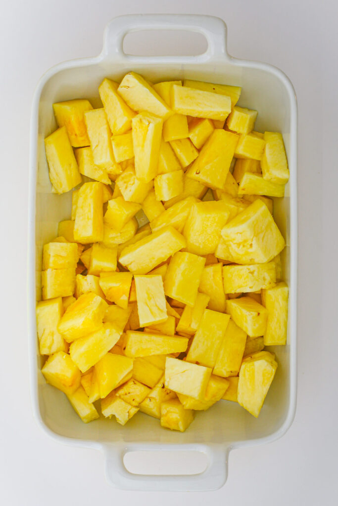 pineapple chunks in a white dish.