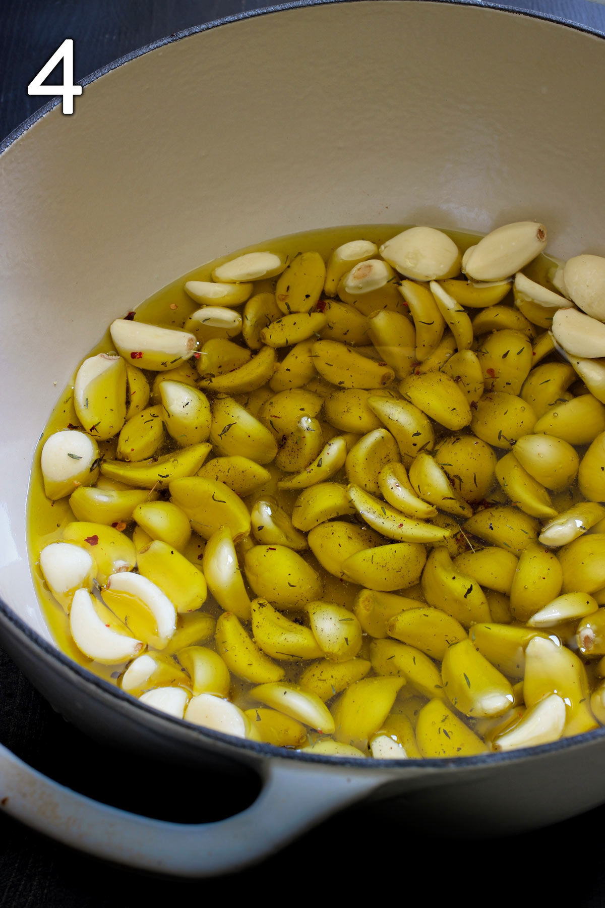 oil and garlic ready to be roasted in dutch oven.