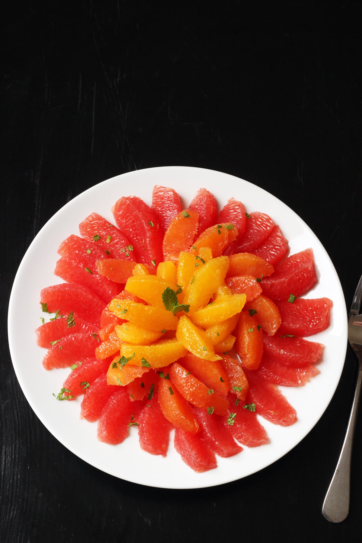 platter of grapefruit and orange sections with chopped fresh mint.