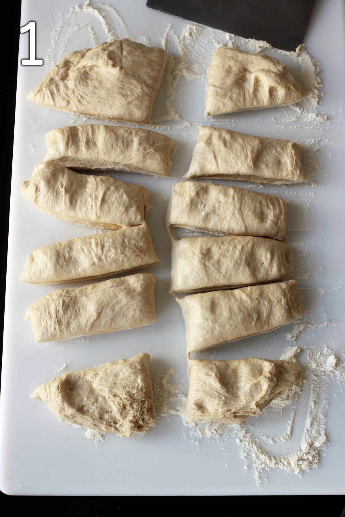dividing dough into 12 portions on floured surface.