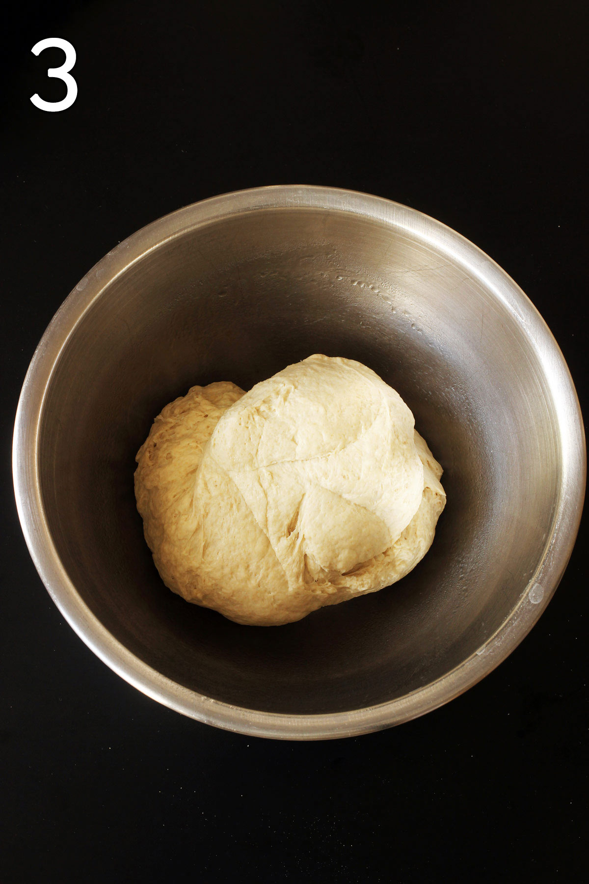 kneaded dough in greased bowl ready to rise.