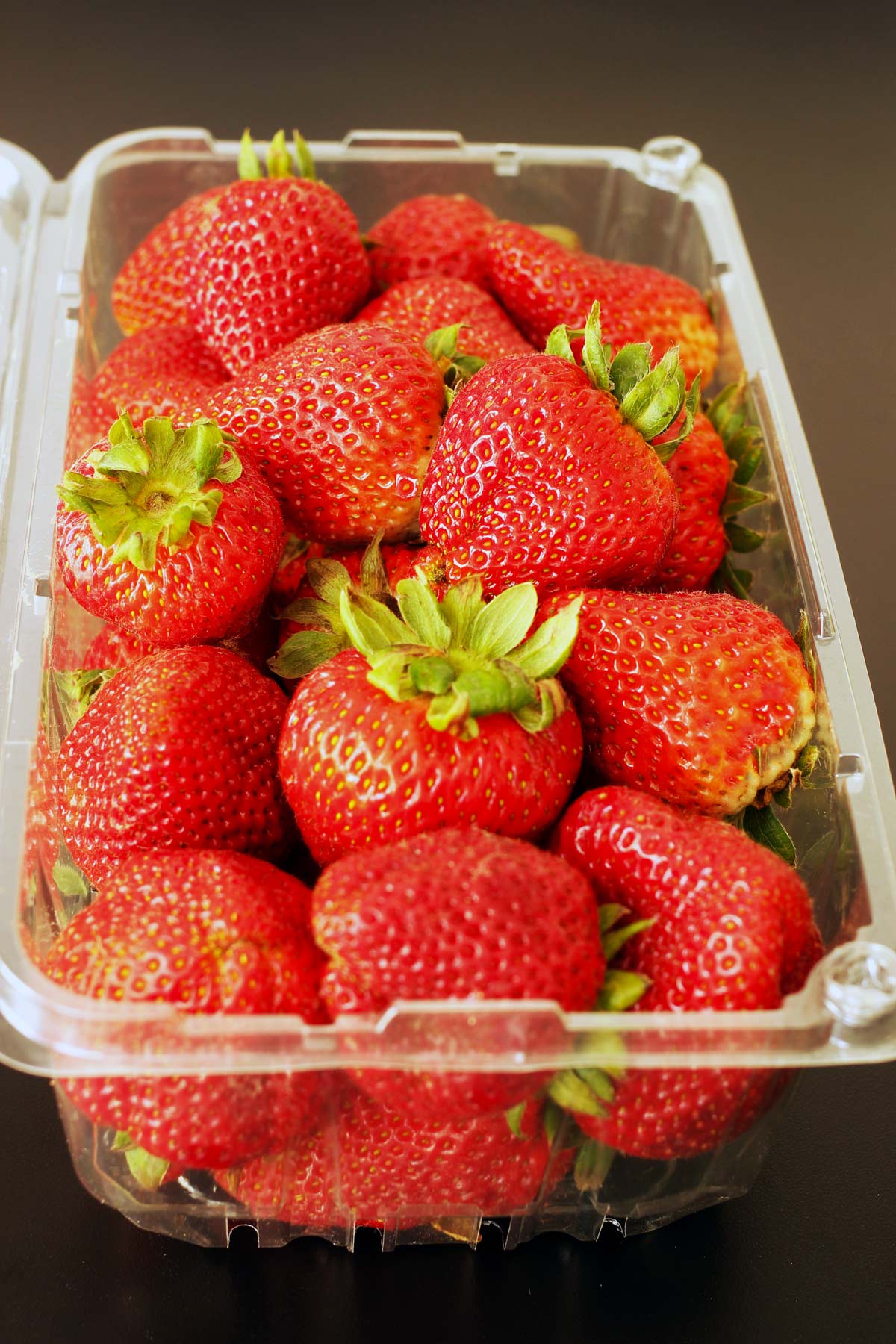 strawberries in plastic clamshell box.